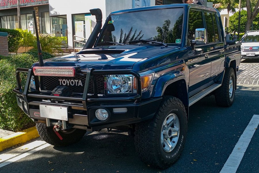 Heavy-duty grille guard and front bumper installed on a Toyota Land Cruiser pickup truck