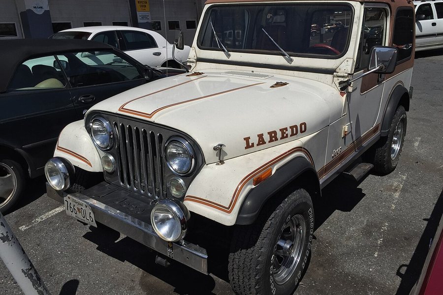 Pair of auxiliary driving lights installed on the front bumper of an off-road Jeep
